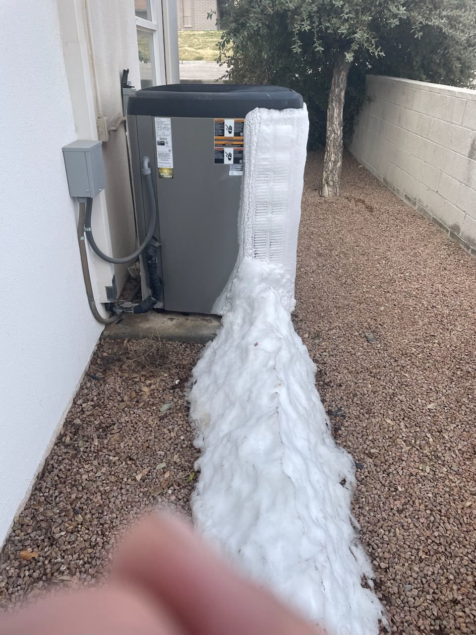 A heat pump outdoor unit iced over on a winter morning in northern Arizona
